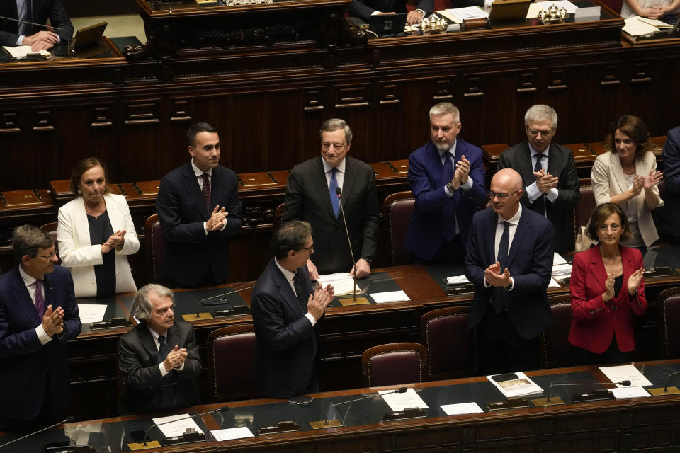 Italian Premier Mario Draghi, background center, delivers his speech at the Parliament in Rome, Thursday, July 21, 2022. Italian Premier Mario Draghi has won a confidence vote in the Senate, but boycotts by three of his key coalition allies in the voting seem likely to have doomed the government's prospects of survival. (AP Photo/Andrew Medichini)