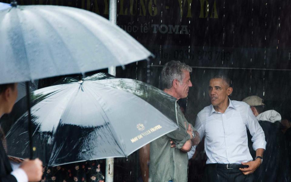 <p>Obama escapes the rain with Anthony Bourdain after meeting for lunch in Hanoi.</p>