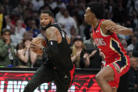 Los Angeles Clippers forward Marcus Morris Sr., left, drives by New Orleans Pelicans forward Herbert Jones during the second half of an NBA basketball play-in tournament game Friday, April 15, 2022, in Los Angeles. The Pelicans won 105-101. (AP Photo/Mark J. Terrill)