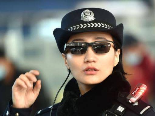 This photo taken on 5 February 2018 shows a police officer wearing a pair of smart glasses with a facial recognition system at Zhengzhou East Railway Station in Zhengzhou in China's central Henan province (AFP/Getty)