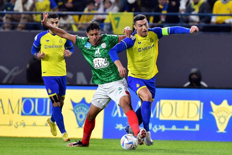 Al Nassr’s Cristiano Ronaldo, right, fights for the ball during the Saudi Pro League match between Al Ettifaq FC and Al Nassr FC at Mrsool Park Stadium, in Riyadh, Saudi Arabia, Sunday, Jan. 22, 2023. (AP Photo) (AP)