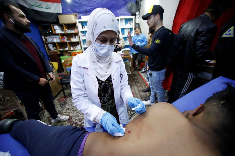 Jassem, 24, an Iraqi nurse helps a wounded man in Baghdad