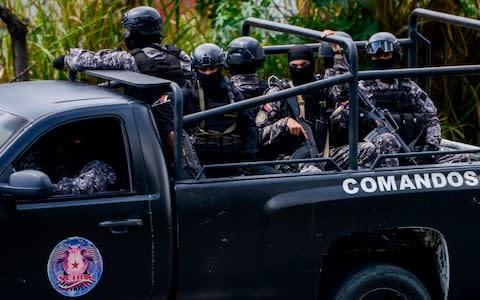 Members of the Bolivarian National Intelligence Service (SEBIN) patrol Caracas as an operation to capture Oscar Perez - Credit: AFP/JUAN BARRETO