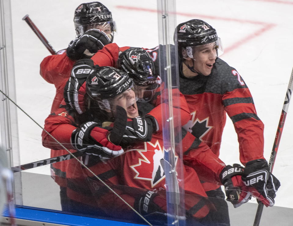 Team Canada's Barrett Hayton (27) celebrates with teammates after scoring a goal during third period action against the United States at the World Junior Hockey Championships in Ostrava, Czech Republic, Thursday, Dec. 26, 2019. (Ryan Remiorz/The Canadian Press via AP)