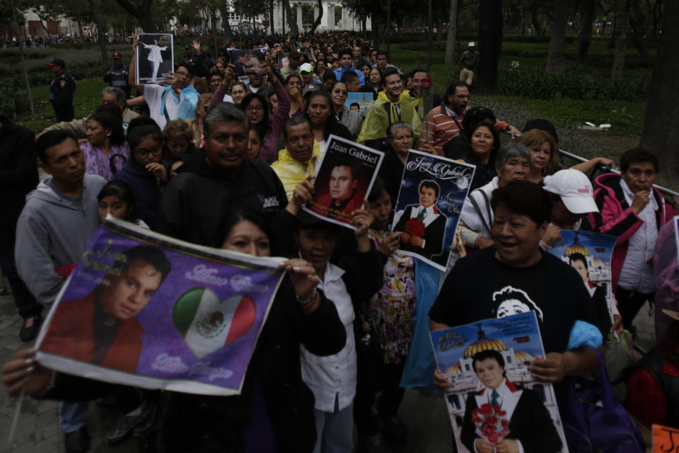 People lineup outside the Palacio de Bellas Artes during the Memorial of Mexican singer Juan Gabriel.