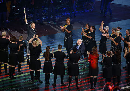 Olympic champion Sir Chris Hoy delivers the baton during the Opening Ceremony.