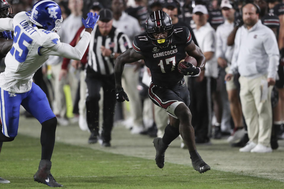 South Carolina wide receiver Xavier Legette (17) runs up the sideline for a first down past Kentucky defensive back Jordan Lovett (25) during the second half of an NCAA college football game on Saturday, Nov. 18, 2023, in Columbia, S.C. (AP Photo/Artie Walker Jr.)