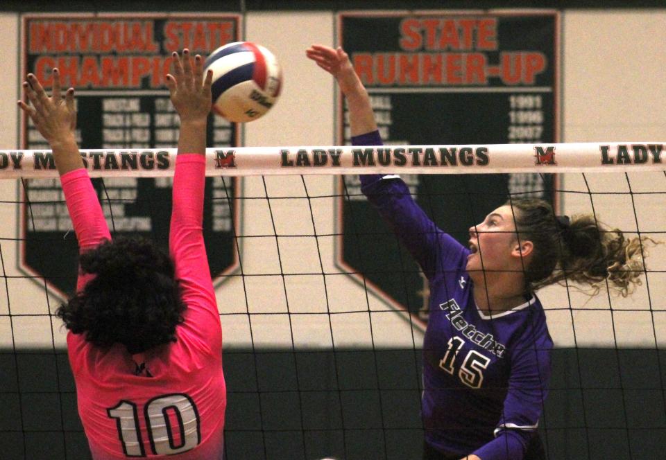 Fletcher outside hitter Alexandra Hennessey (15) spikes the ball as Mandarin's Sheyla Flatt (10) tries to block during the Gateway Conference high school volleyball final. Hennessey was selected to the All-Gateway team for the third year.