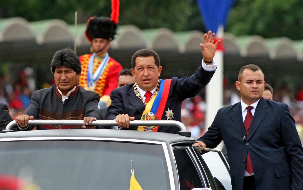 The late Venezuelan president Hugo Chavez (in car, right) with Bolivian president Evo Morales (left) - WARNING: Use of this copyright image is subject to the terms of use of BBC Pictures' Digital Picture