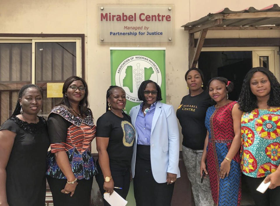 In this April 2018 photo provided by Dr. Charmaine Emelife, Emelife, second from left, poses for a photo during a mission by the Association of Nigerian Physicians in the Americas (ANPA) to make a monetary donation to the Mirabel Center, which provides medical and psychosocial services to survivors of sexual assault and rape, in Lagos, Nigeria. The annual trip to Nigeria to provide free medical care — the flagship project of ANPA — can't go on. Now the 4,000-member organization, like diaspora medical groups around the world, is scrambling for other ways to help back home, where it might be more needed than ever before. (Courtesy of Dr. Charmaine Emelife via AP)