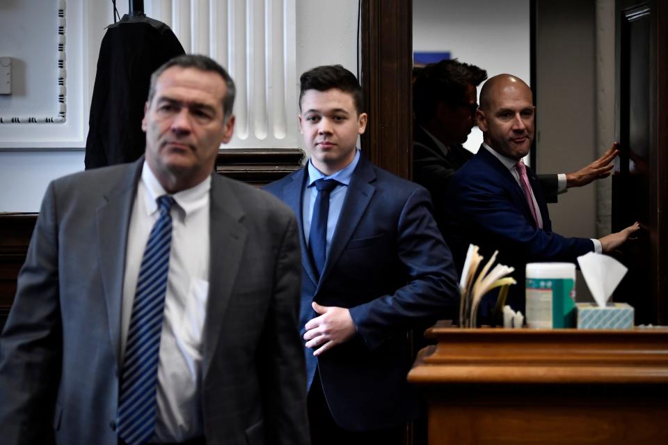 Kyle Rittenhouse, center, enters the courtroom with his attorneys Mark Richards, left, and Corey Chirafisi for a meeting called by Judge Bruce Schroeder at the Kenosha County Courthouse on Thursday, Nov. 18. A film crew was following Rittenhouse and his defense team for a documentary with Tucker Carlson of Fox News.