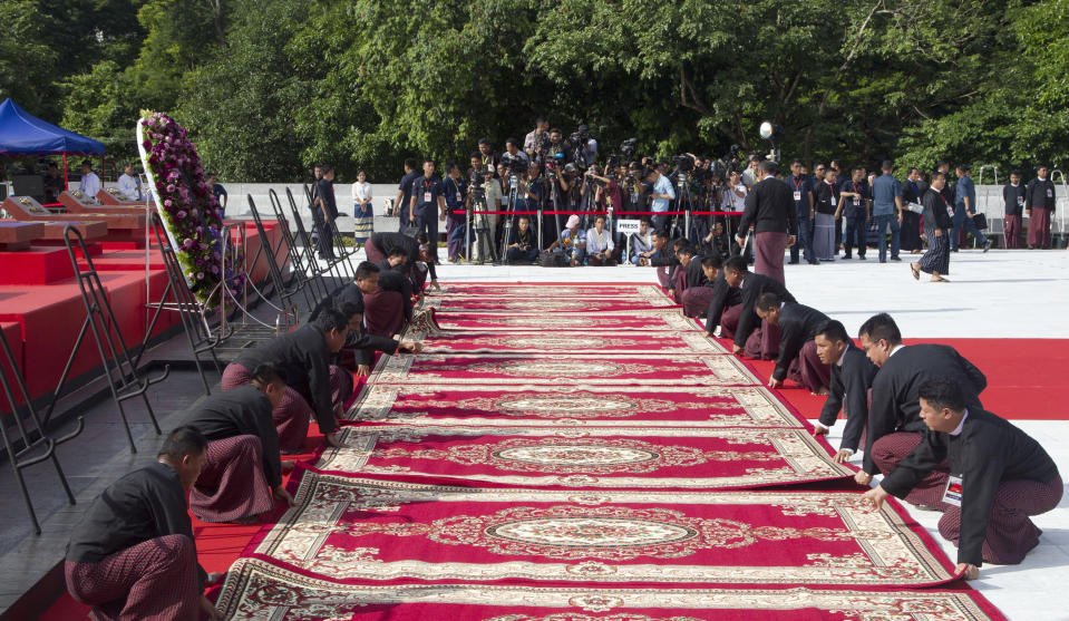 Myanmar officials arrange carpets in front of the tomb of Myanmar's independence hero Gen. Aung San during a ceremony to mark the 72nd anniversary of his 1947 assassination, at the Martyrs' Mausoleum Friday, July 19, 2019, in Yangon, Myanmar. The country's Independence hero Gen. Aung San and his cabinet were gunned down in 1947. (AP Photo/Thein Zaw)