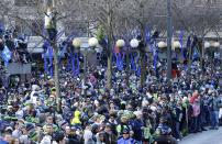 Seattle Seahawks fans line the street during the Super Bowl champions parade on Wednesday, Feb. 5, 2014, in Seattle. The Seahawks beat the Denver Broncos 43-8 in NFL football's Super Bowl XLVIII on Sunday. (AP Photo/Ted S. Warren)