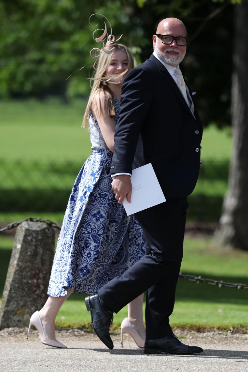 <p>Pippa’s uncle arrived in a traditional suit with his daughter opting for a printed blue-and-white dress.<br><i>[Photo: PA]</i> </p>