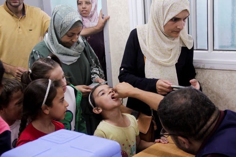 Palestinian children are vaccinated against polio, in Jabalia