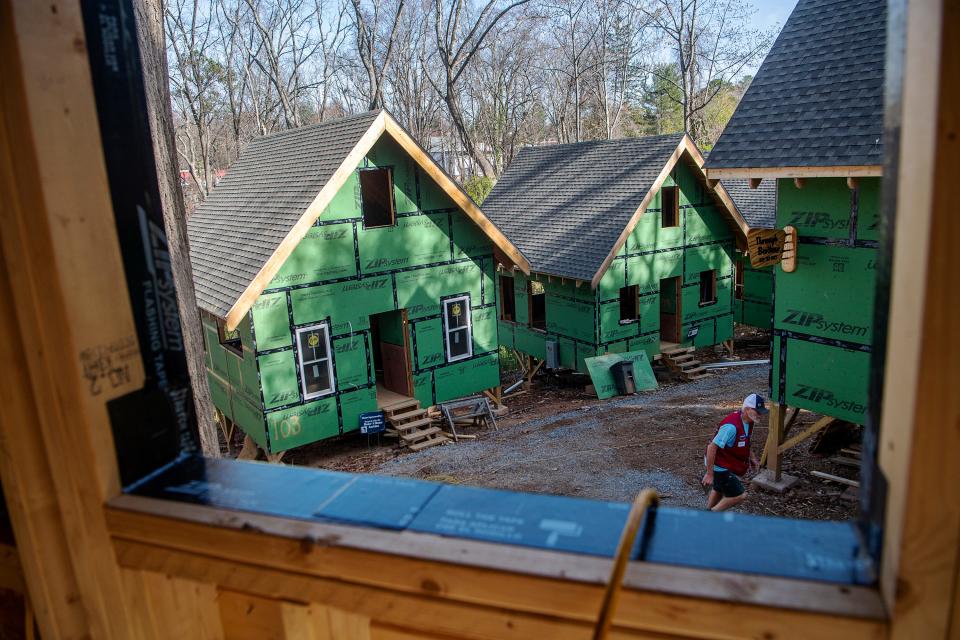 Volunteers work on the final stages of framing at the BeLoved Village, November 14, 2023, in Asheville.