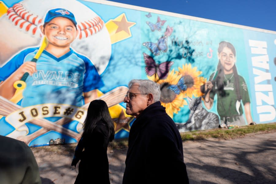 Attorney General Merrick Garland, right, and Associate Attorney General Vanita Gupta, left, tour murals of shooting victims, Wednesday, Jan. 17, 2024, in Uvalde, Texas. The Justice Department is planning this week to release findings of an investigation into the 2022 school shooting. (AP Photo/Eric Gay)