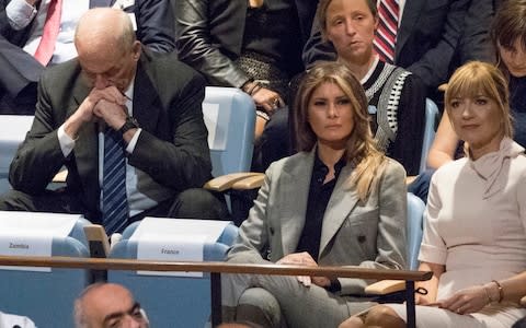 White House Chief of Staff John Kelly, left, reacts as he and first lady Melania Trump listen to U.S. President Donald Trump speak at the United Nations General Assembly  - Credit: AP