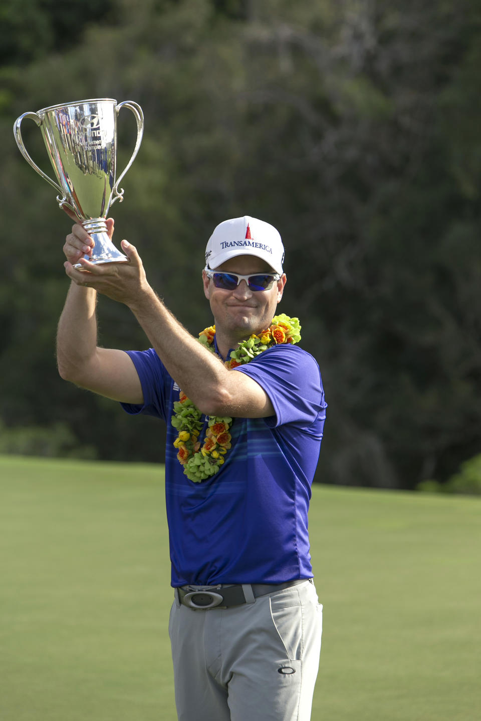 Zach Johnson holds the first place trophy after winning the Tournament of Champions golf tournament, Monday, Jan. 6, 2014, in Kapalua, Hawaii. Johnson pulled away with three straight birdies on the back nine at Kapalua and closed with a 7-under 66 for a one-shot victory over Jordan Spieth on Monday. (AP Photo/Marco Garcia)