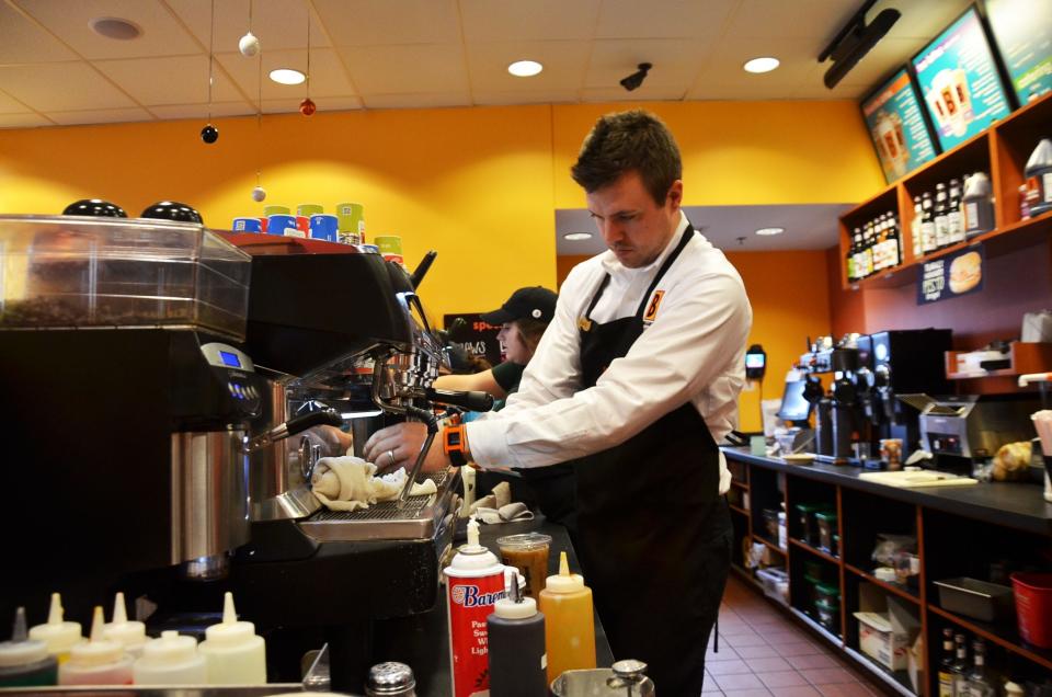 Mark Dykema, then owner of Biggby Coffee on Chicago Drive in Holland, makes a drink in 2014.