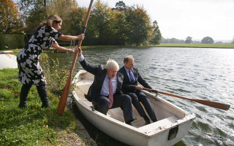 Boris Johnson's wife, Marina Wheeler, helps as the Foreign Secretary boards a row boat with Czech Republic's Deputy Foreign Minister Ivo Sramek - Credit: AFP