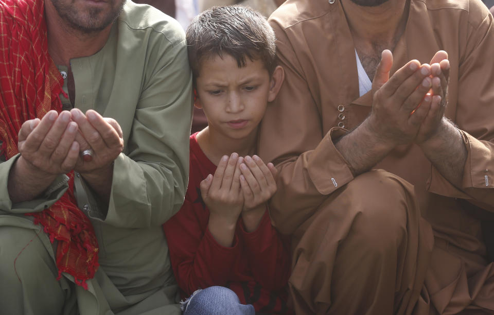 Afghan Muslims attend Eid al-Adha prayers in Kabul, Afghanistan, Sunday, Aug. 11, 2019. Muslim people in the country celebrate Eid al-Adha, or the Feast of the Sacrifice by slaughtering sheep, goats and cows whose meat will later be distributed to the poor.(AP Photo/Rafiq Maqbool)