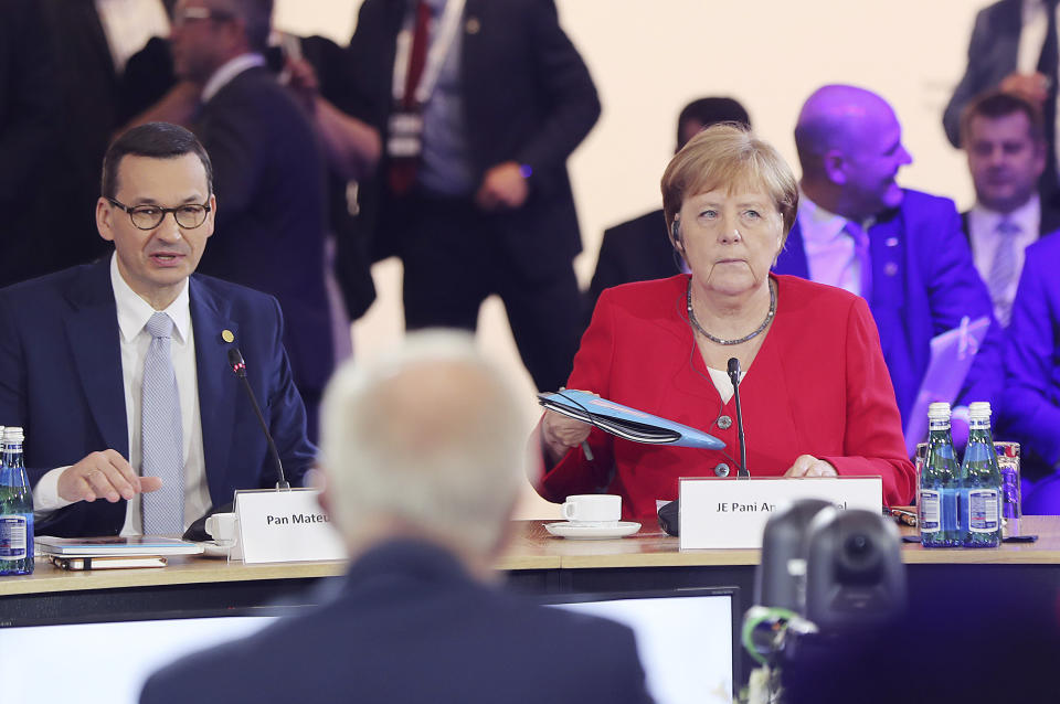 German Chancellor Angela Merkel,right, and Poland's Prime Minister Mateusz Morawiecki listening to a speech by Poland's President Andrzej Duda during a summit meeting that aims to reassure Western Balkan states that their aspirations to join the European Union have backing among EU leaders, in Poznan, Poland, Friday, July 5, 2019.(AP Photo/Czarek Sokolowski)