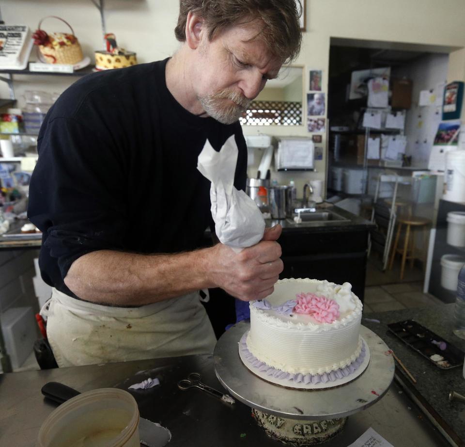 In this March 10, 2014 photo, Masterpiece Cakeshop owner Jack Phillips decorates a cake inside his store, in Lakewood, Colo. Phillips is appealing a recent ruling against him in a legal complaint filed with the Colorado Civil Rights Commission by a gay couple he refused to make a wedding cake for, based on his religious beliefs. (AP Photo/Brennan Linsley)
