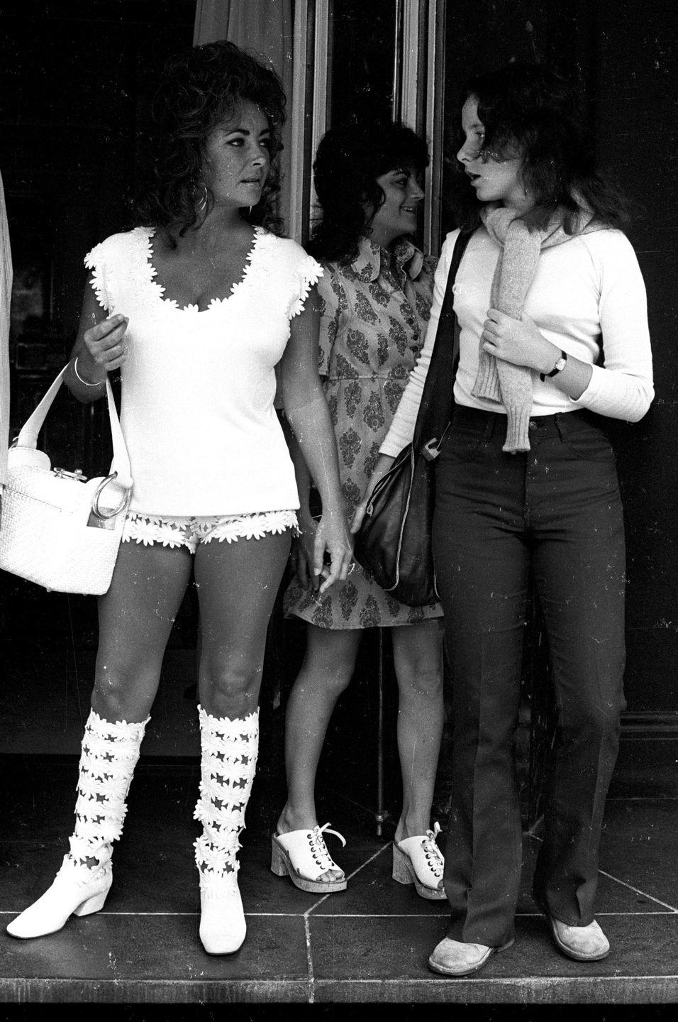 <p>Elizabeth dresses in floral boots and white hot pants for a day out with her eldest daughter, Elizabeth Liza Todd. </p>