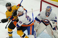 New York Islanders center Brock Nelson (29) defends against Boston Bruins center David Krejci (46) as Islanders goaltender Semyon Varlamov (40) protects the net in the first period of an NHL hockey game, Thursday, April 15, 2021, in Boston. (AP Photo/Elise Amendola)