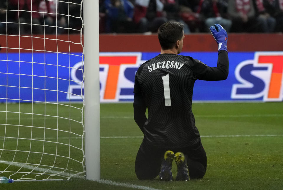 FILE - Poland goalkeeper Wojciech Szczesny reacts after Hungary's Andras Schafer scoring his side's opening goal during the World Cup 2022 group I qualifying soccer match between Poland and Hungary, at the Narodowy stadium in Warsaw, Poland, Monday, Nov. 15, 2021. (AP Photo/Czarek Sokolowski, File)