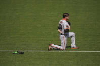 San Francisco Giants' Austin Slater kneels during the national anthem before a baseball game against the Oakland Athletics in Oakland, Calif., Sunday, Sept. 20, 2020. (AP Photo/Jeff Chiu)