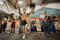 In this Monday Oct. 21, 2019 photo provided by Eddy Alexander, Wiyot Brush Dancers lead a ceremonial performance for the hundreds of supporters after a deed transfer of Indian Island in Eureka, Calif. Off the coast of Northern California, Indian Island was the site of a massacre, contaminated by a shipyard and flush with invasive species. It's also the spiritual and physical center of the universe for the small Wiyot Tribe, and it now belongs to them almost entirely after a city deeded all the land it owns on the island to the tribe during a packed signing ceremony Monday. (Eddy Alexander via AP)