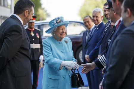 Britain's Queen Elizabeth is accompanied by Chief Executive of British Airways, Alex Cruz, as she greets company executives during her visit to the headquarters of British Airways, as British Airways mark their centenary year, in Heathrow, west London, Britain May 23, 2019. Tolga Akmen/Pool via REUTERS