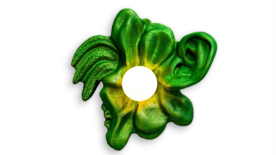 green and yellowish sconce that looks like an amorphous flower with one petal that looks curled like an ear
