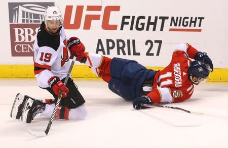 Apr 6, 2019; Sunrise, FL, USA; New Jersey Devils center Travis Zajac (19) collides Florida Panthers left wing Jonathan Huberdeau (11) in the first period at BB&T Center. Mandatory Credit: Robert Mayer-USA TODAY Sports