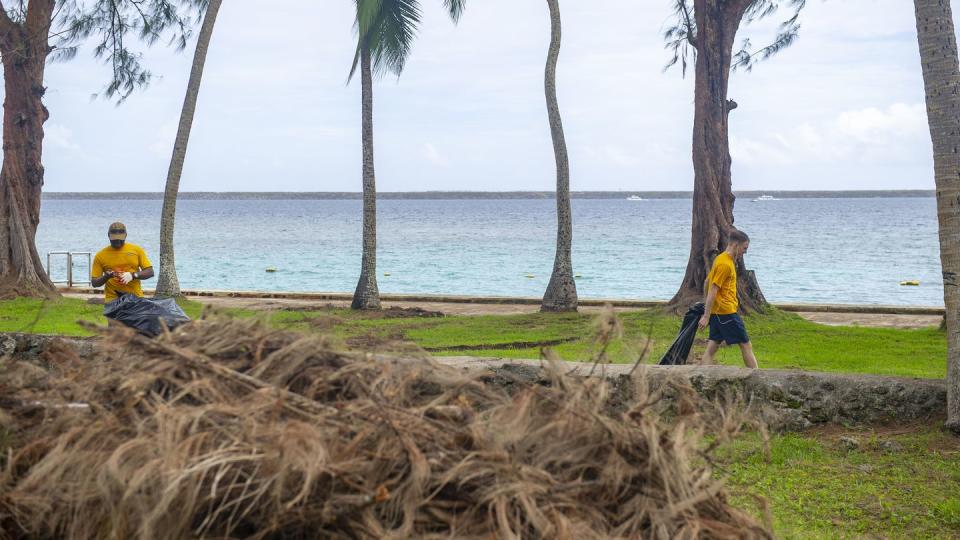 U.S. Navy Reserve sailors pick up debris from Typhoon Mawaat on Gab Gab Beach at Naval Base Guam June 7. (MC1 Joshua M. Tolbert/Navy)