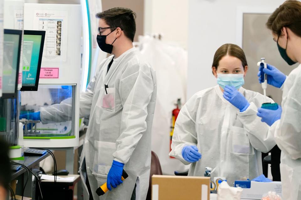 Sonora Quest Laboratory medical laboratory scientists oversee COVID-19 PCR tests at Sonora Quest Laboratories Tuesday, Jan. 11, 2022, in Phoenix. As Arizona's largest diagnostic testing lab, Sonora Quest went through almost 30,000 COVID-19 PCR tests on Jan. 4, the most since the pandemic began. (AP Photo/Ross D. Franklin)