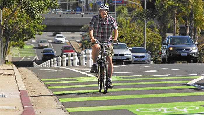 Brent Butterworth rides his bike on a protected bike lane on Reseda Boulevard in this file photo. (Credit: Anne Cusack / Los Angeles Times)