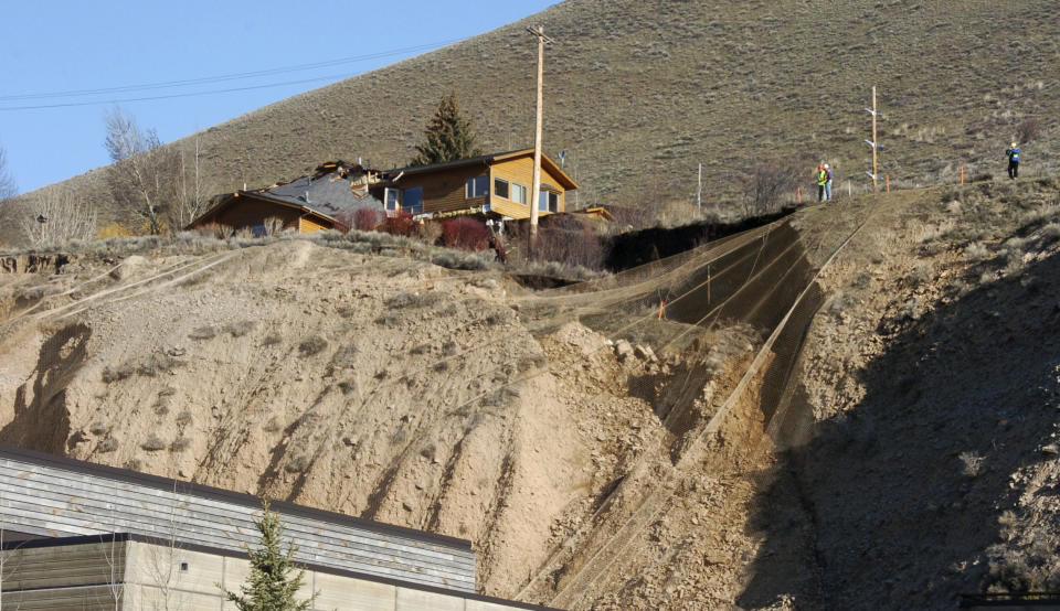 A slow-motion landslide is seen Saturday, April 19, 2014, on East Gros Ventre Butte in Jackson, Wyo. No one can say when the mountainside collapsing into this Wyoming resort town will give way. But it appears increasingly likely that when it does, it's going to take a piece of Jackson with it. (AP Photo/Matthew Brown)