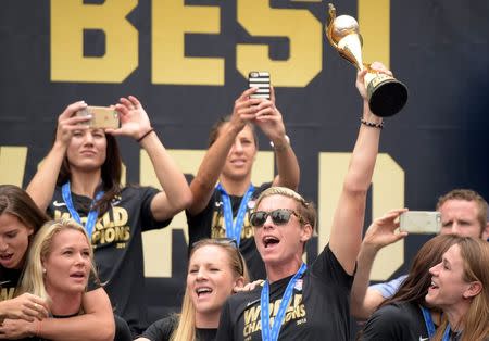 Jul 7, 2015; Los Angeles, CA, USA; United States forward Abby Wambach hoists the FIFA World Cup trophy at 2015 Womens World Cup champions celebration at Microsoft Square at L.A. Live. Mandatory Credit: Kirby Lee-USA TODAY Sports
