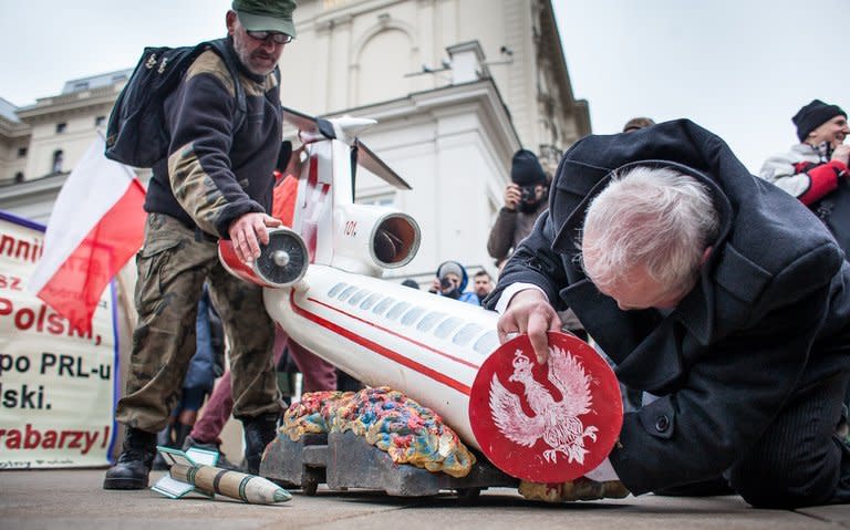 Two men prepare a sculpture depicting a crashed plane ahead of a ceremony marking the third anniversary of the crash in Smolensk, in front of the presidential palace in Warsaw on April 10, 2013. Poland's opposition leader laid flowers Wednesday in honour of twin and ex-president Lech Kaczynski, who died in a jet crash in Russia three years ago that one third of Poles believe was an assassination