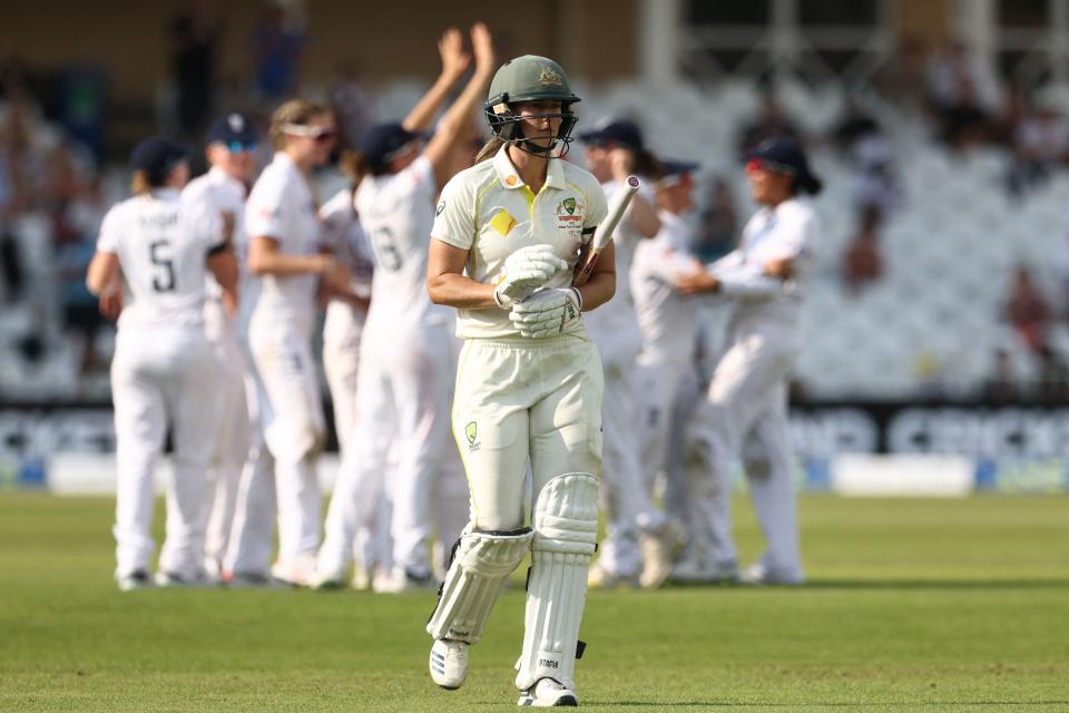 Ellyse Perry walks off the field after being dismissed.