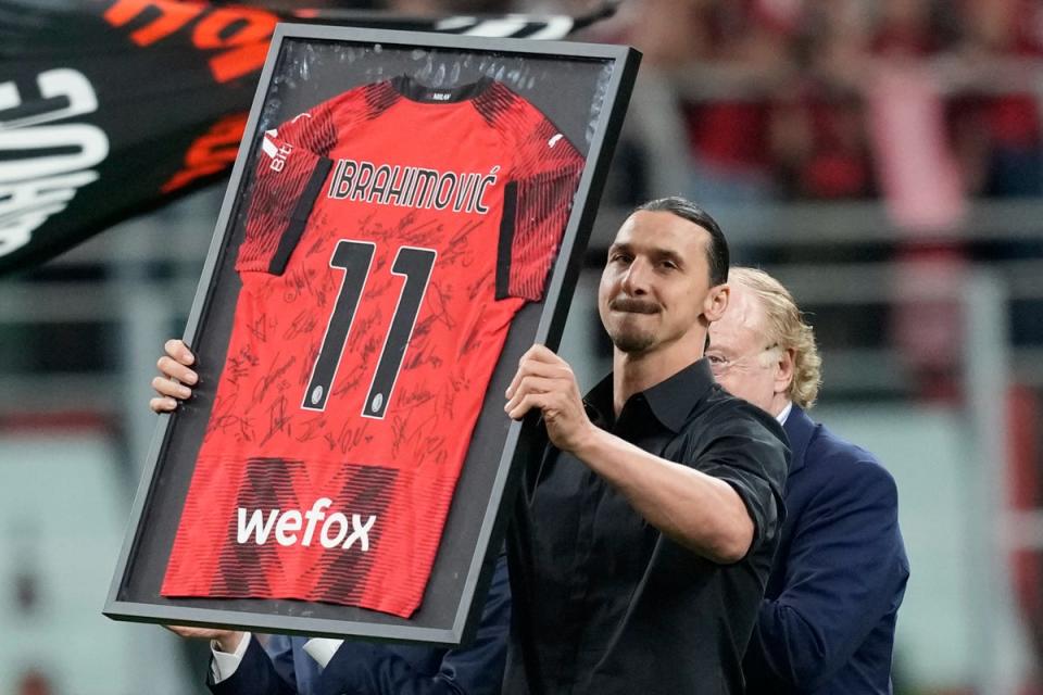 Zlatan was presented with a special signed shirt as he was mobbed by his Milan team-mates (AP)