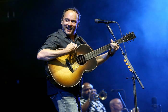 Dave Matthews playing guitar at a microphone