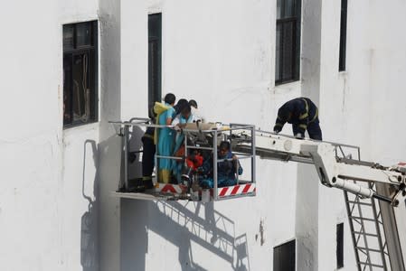 Firemen rescue people from Mahanagar Telephone Nigam Limited (MTNL) building after a fire broke out, in Mumbai