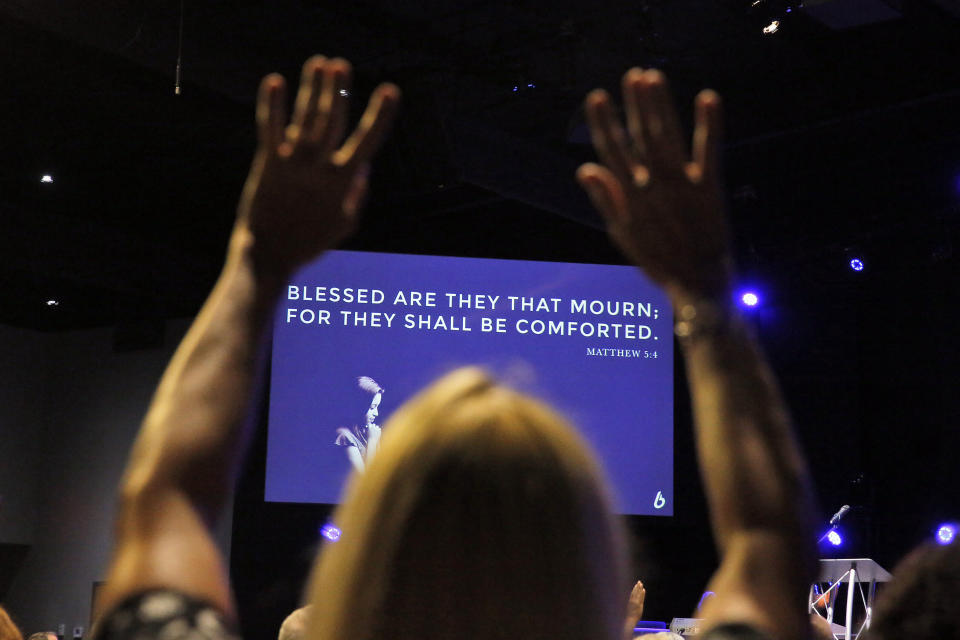 Community members pray during a vigil for the victims of the mass shooting at the Bridge Church, Saturday, June 1, 2019 in Virginia Beach, Va. DeWayne Craddock, a longtime city employee, opened fire at the municipal building Friday before police shot and killed him, authorities said. (Jonathon Gruenke/The Virginian-Pilot via AP)