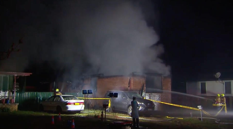 Black smoke billows from a home on Brittcliffe Close in Singleton on Wednesday morning in the dark. Three kids, who were inside, have died. A boy aged 11 and two girls, both aged 5. A woman, 31, and eight-year-old boy were treated at John Hunter Hospital. 