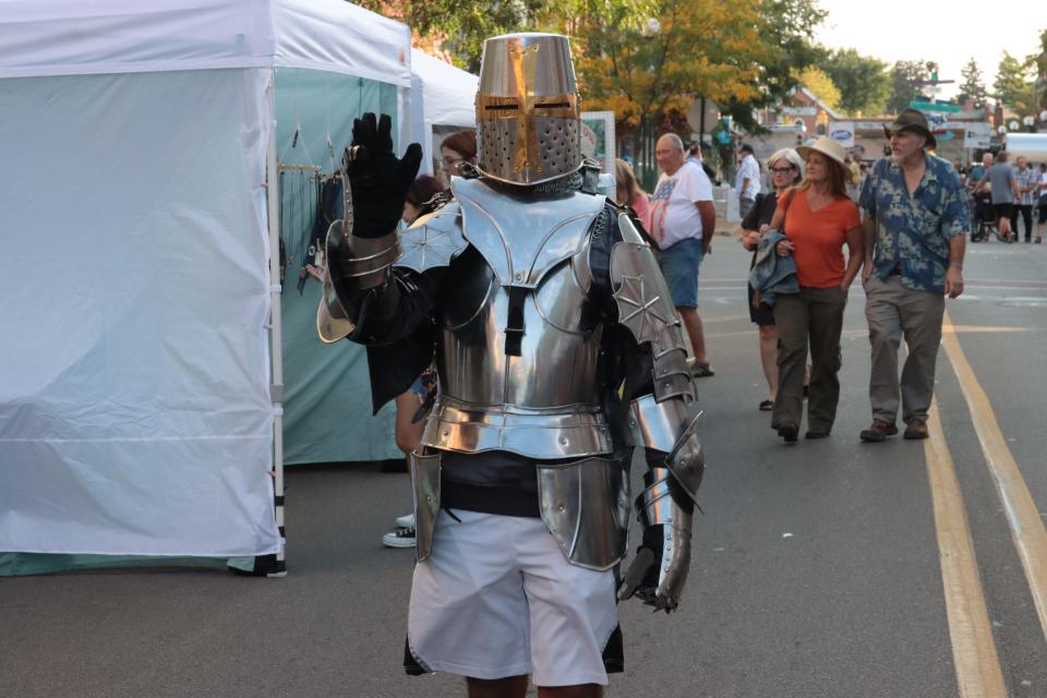 David Garcia of Adrian visits the Artalicious Fine Arts Fair while dressed in a suit of armor Saturday, Sept. 18, 2021, in downtown Adrian.