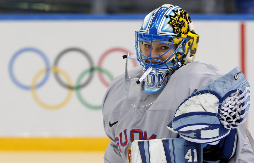 Goalkeeper of Finland's women's ice hockey team Noora Raty catches a puck during a practice session ahead of the 2014 Winter Olympics, Thursday, Feb. 6, 2014, in Sochi, Russia. (AP Photo/Petr David Josek)